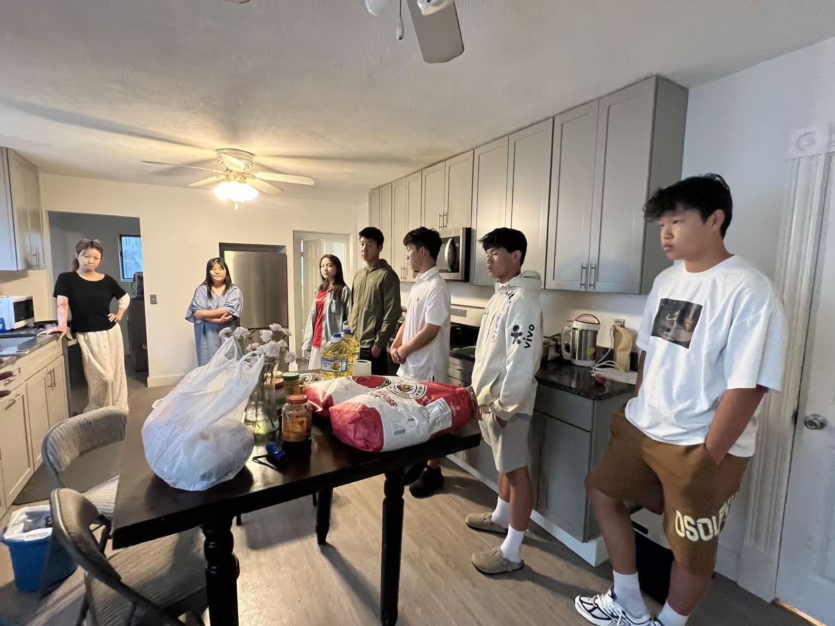 Volunteers visiting with groceries and household supplies
