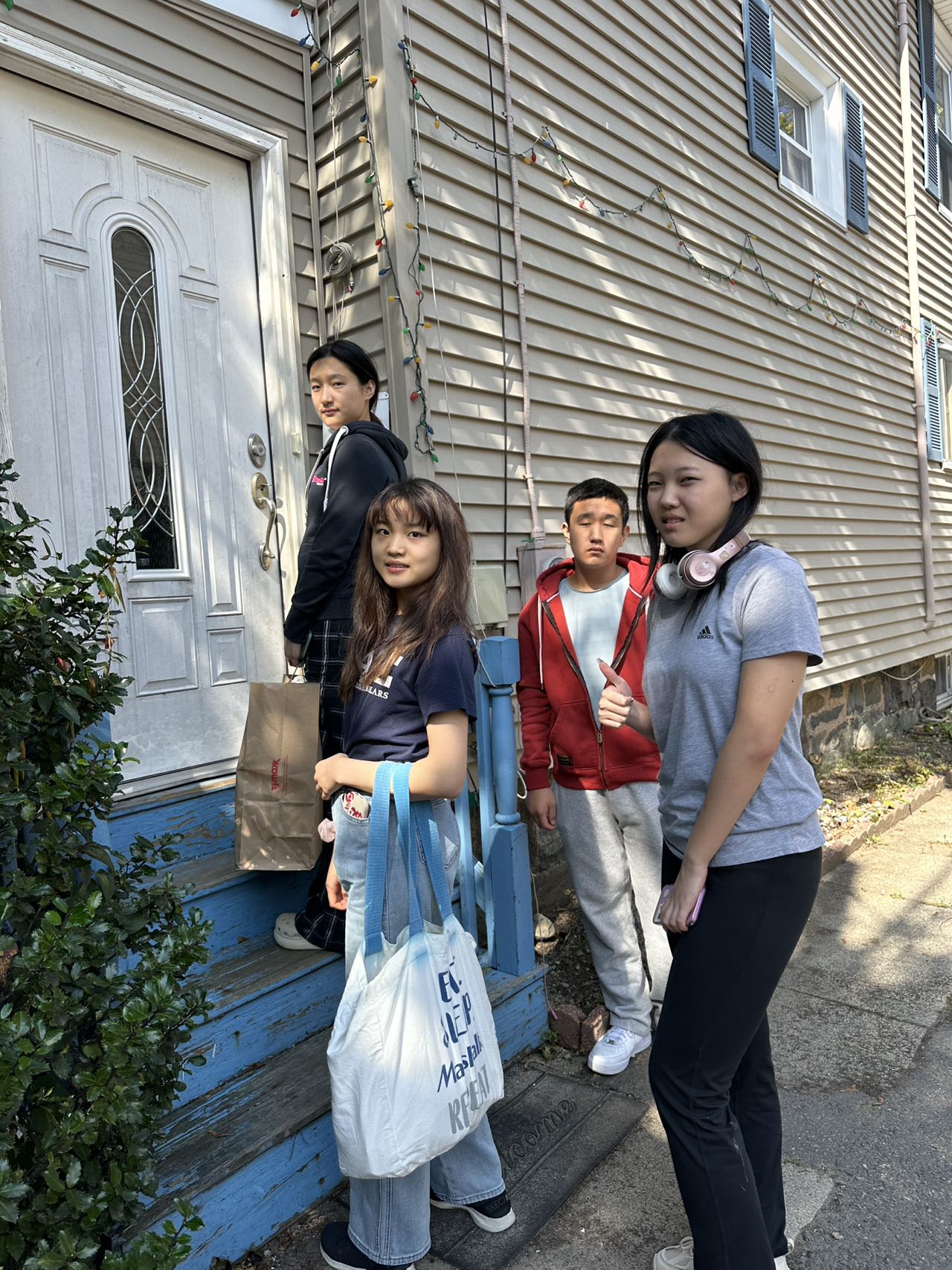 Volunteers carrying bags of supplies during a community visit